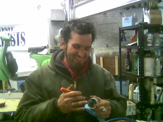 John Geiger inspects a teeny-tiny piston.
