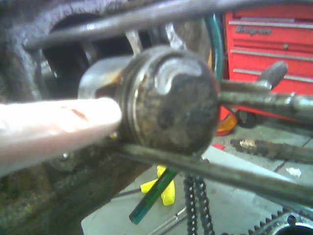 This is what happens to a CT70 piston when the timing chain loses tension and the intake valve tries to occupy the same space at the same time. Can you say "bust-o-lated?"