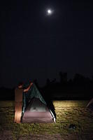tent assembly by moonlight
